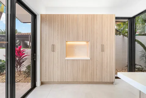 an empty room with windows and ceiling fan