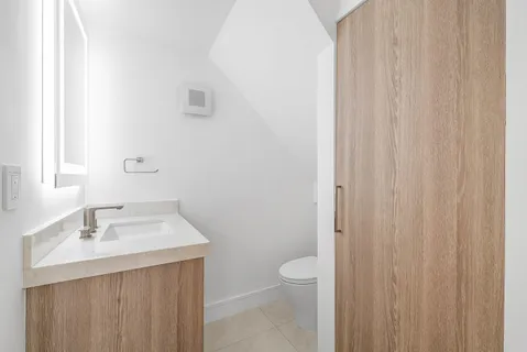 a view of an empty room with a window and a ceiling fan