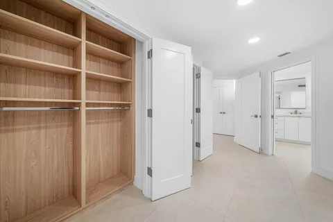 a spacious bathroom with a double vanity sink and a mirror