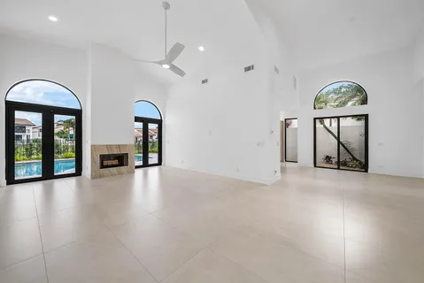 an empty room with windows cabinet and mountain view
