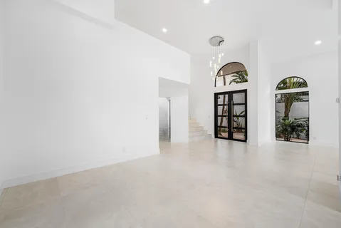 a large kitchen with kitchen island a large counter top space a sink stainless steel appliances and cabinets