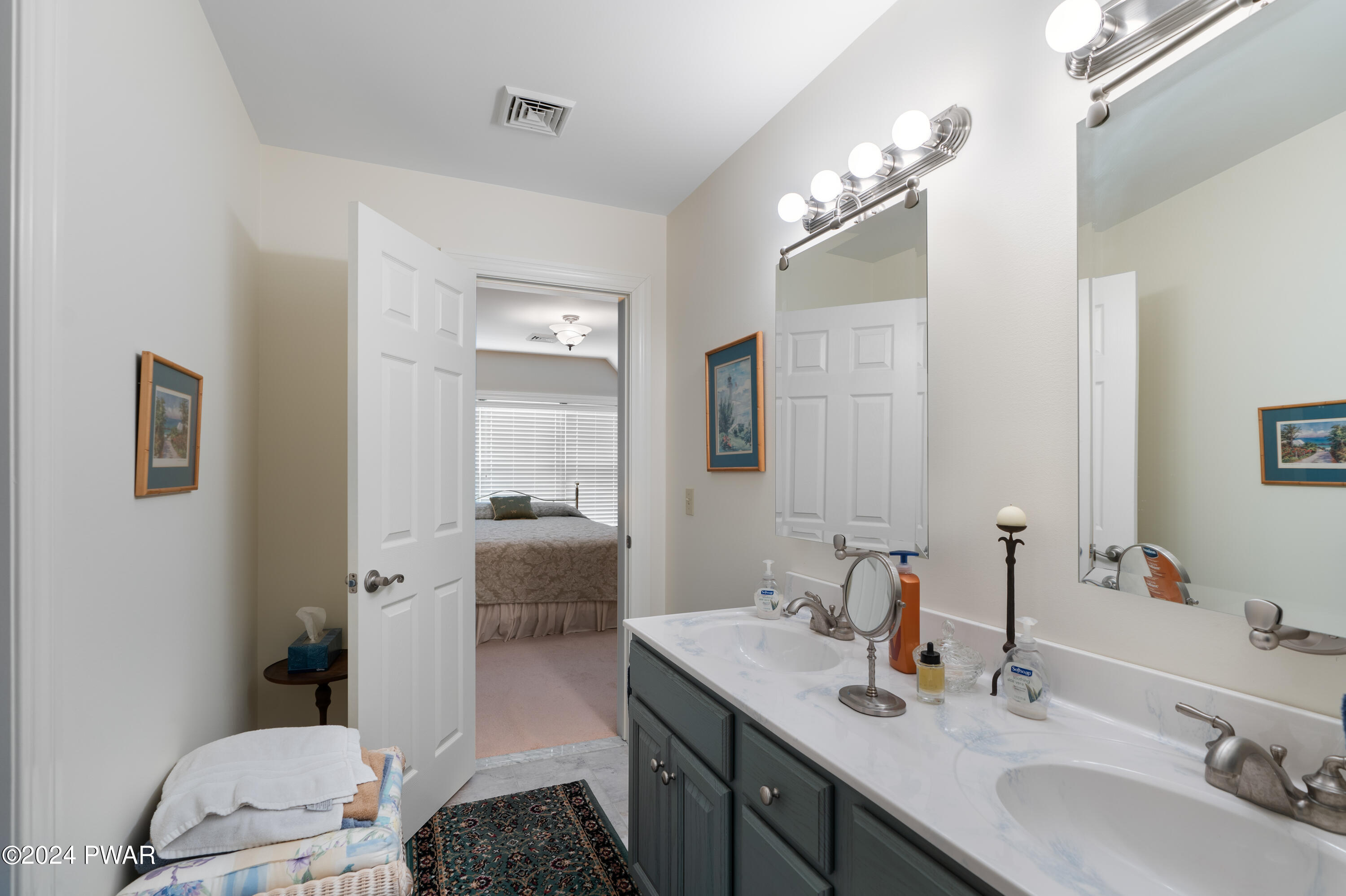 208 Long Meadow Road Milford, PA 18337 - Photo 39 of 64 a bathroom with a sink a toilet and mirror