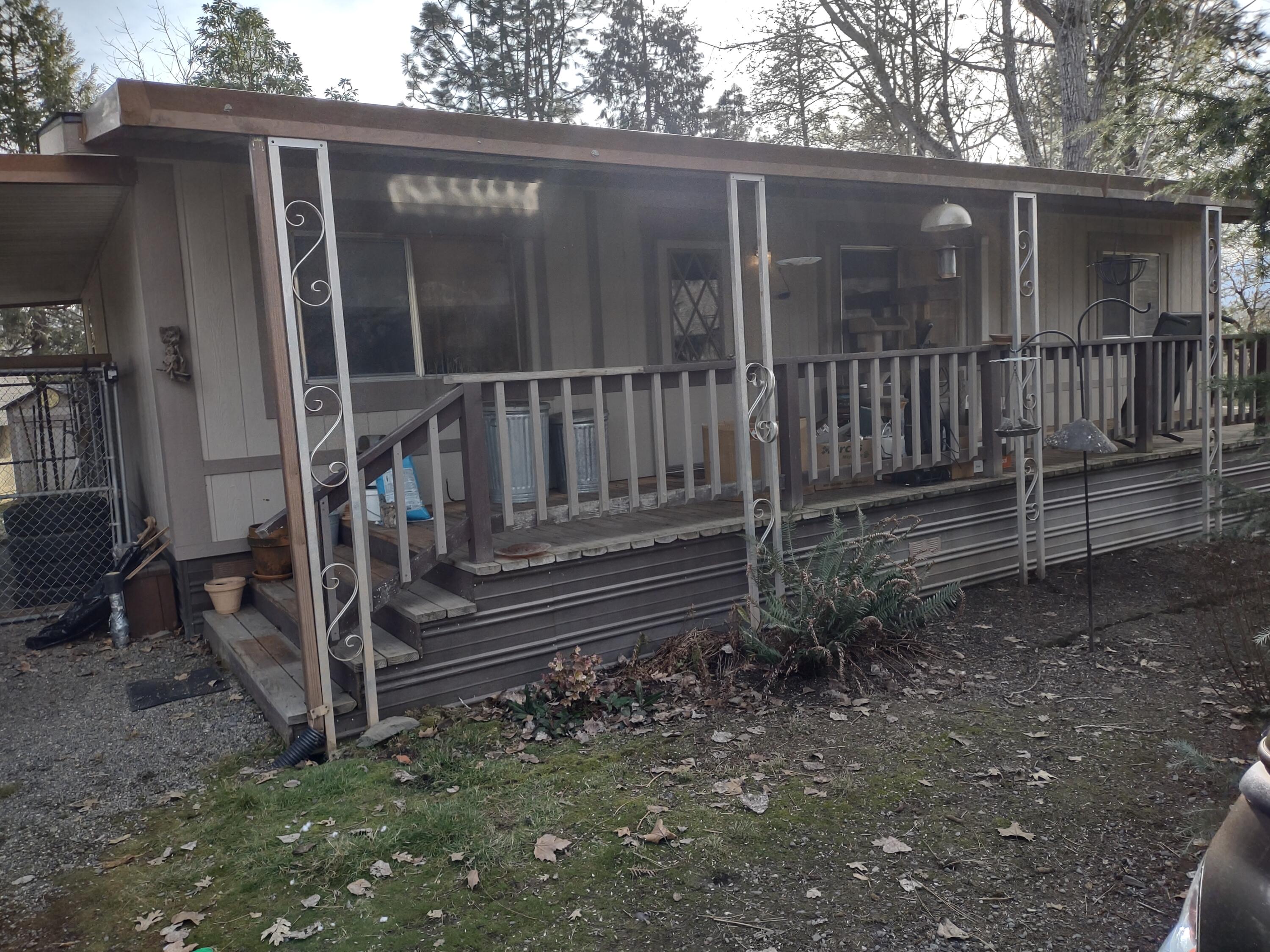 241 Gunnell Road Grants Pass, OR 97526 - Photo 3 of 23 a view of a house with backyard and wooden fence