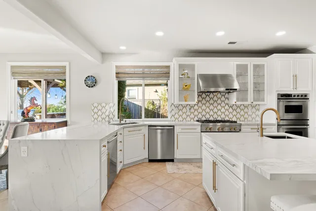 a kitchen with a stove a sink and a refrigerator