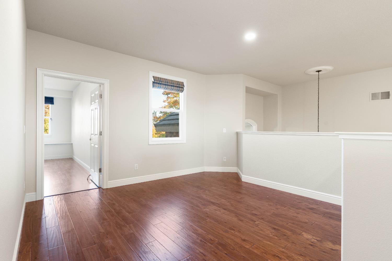 1580 Vista Ridge Way Roseville, CA 95661 - Photo 35 of 58 an empty room with wooden floor and windows