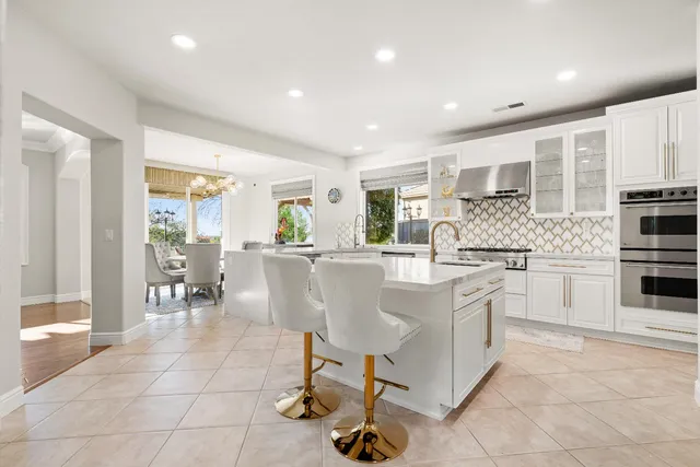 a kitchen with granite countertop a sink stainless steel appliances and cabinets