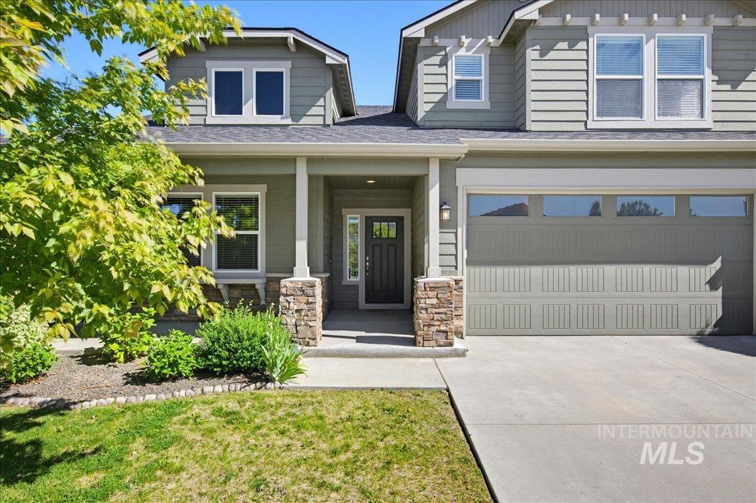 12460 West Azure Street Boise, ID 83713 - Photo 1 of 34 Two-story residence featuring light green siding and a dark gray shingle roof