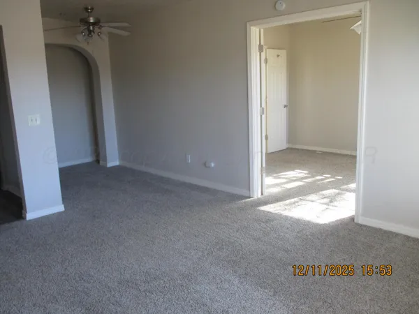a view of a big room with closet and windows
