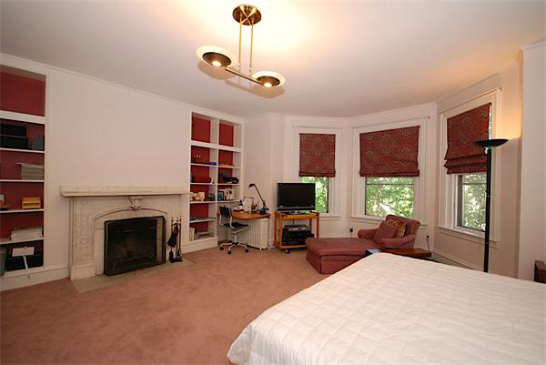 87 Perry Street Brookline, MA 02446 - Photo 12 of 12 a bedroom with a bed flat screen tv and windows