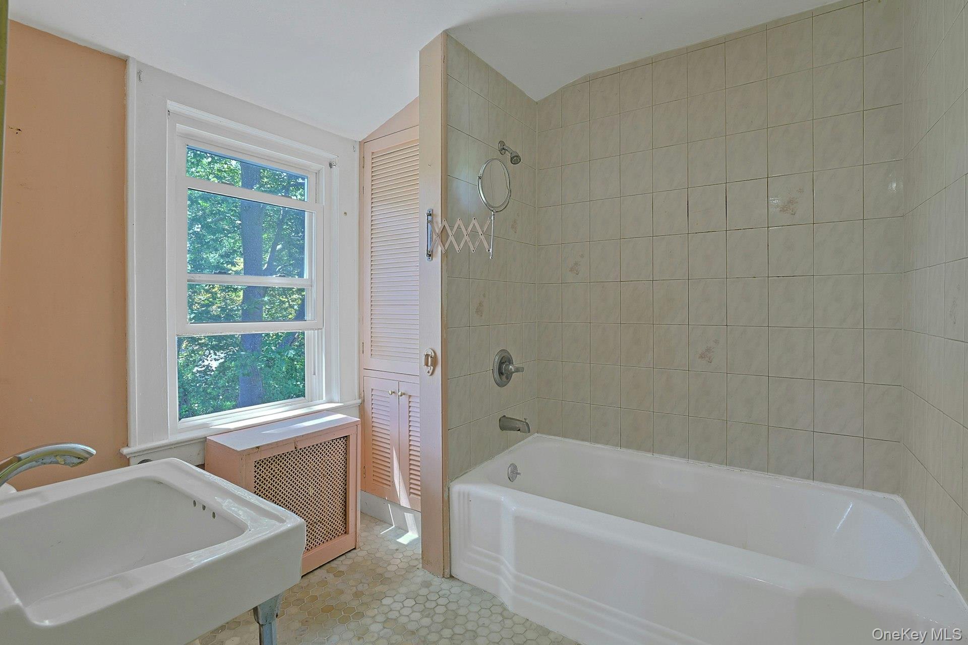 333 South Middletown Road Nanuet, NY 10954 - Photo 19 of 22 a bathroom with a tub a sink a window and a shower