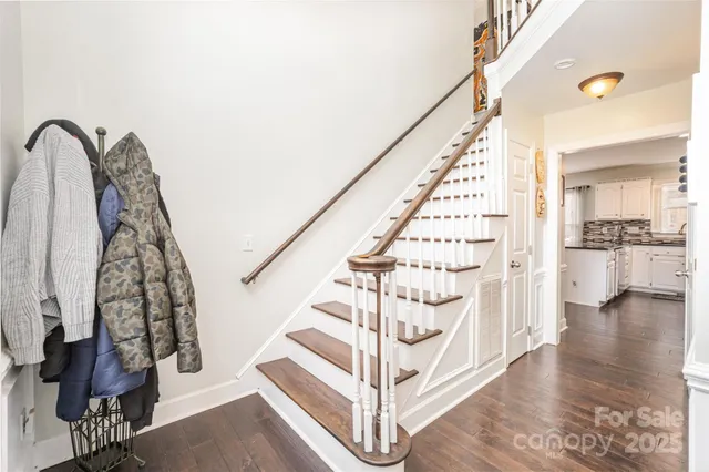 a view of entryway with wooden floor and stairs