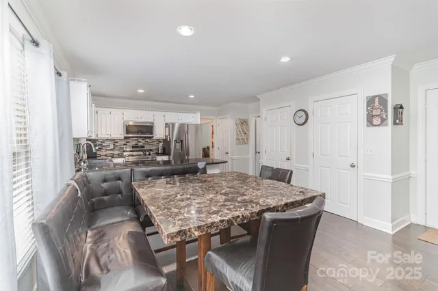 a large kitchen with a table and chairs