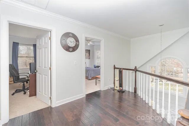a view of a hallway with wooden floor and a hallway