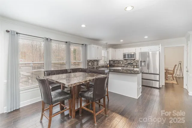 a kitchen with kitchen island wooden cabinets and counter space
