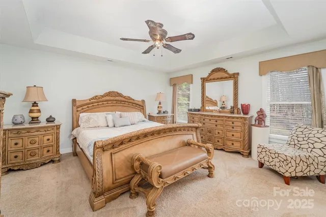 a bedroom with a bed and ceiling fan