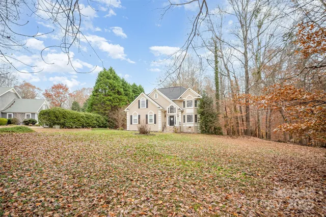 a big house with large trees and a big yard