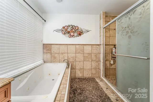 a bathroom with a bathtub and shower