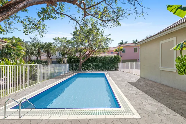 a bedroom with a bed and a potted plant