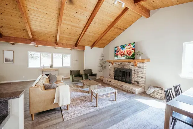 a living room with furniture a fireplace and a table