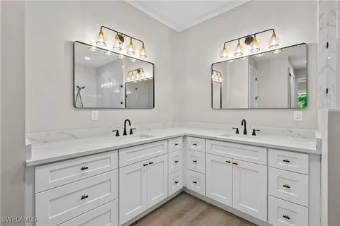 a bathroom with a granite countertop sink mirror and