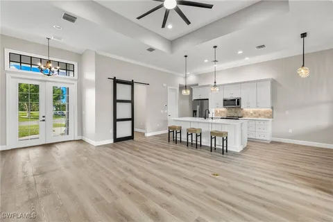 a living room with stainless steel appliances kitchen island granite countertop furniture and a kitchen view
