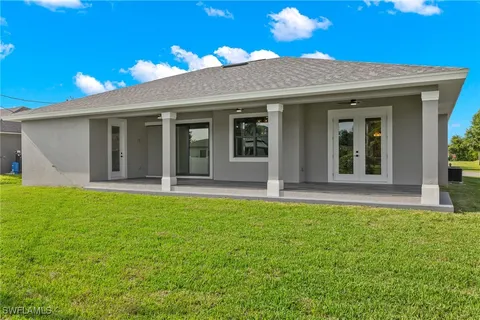 a view of a house with backyard porch and garden