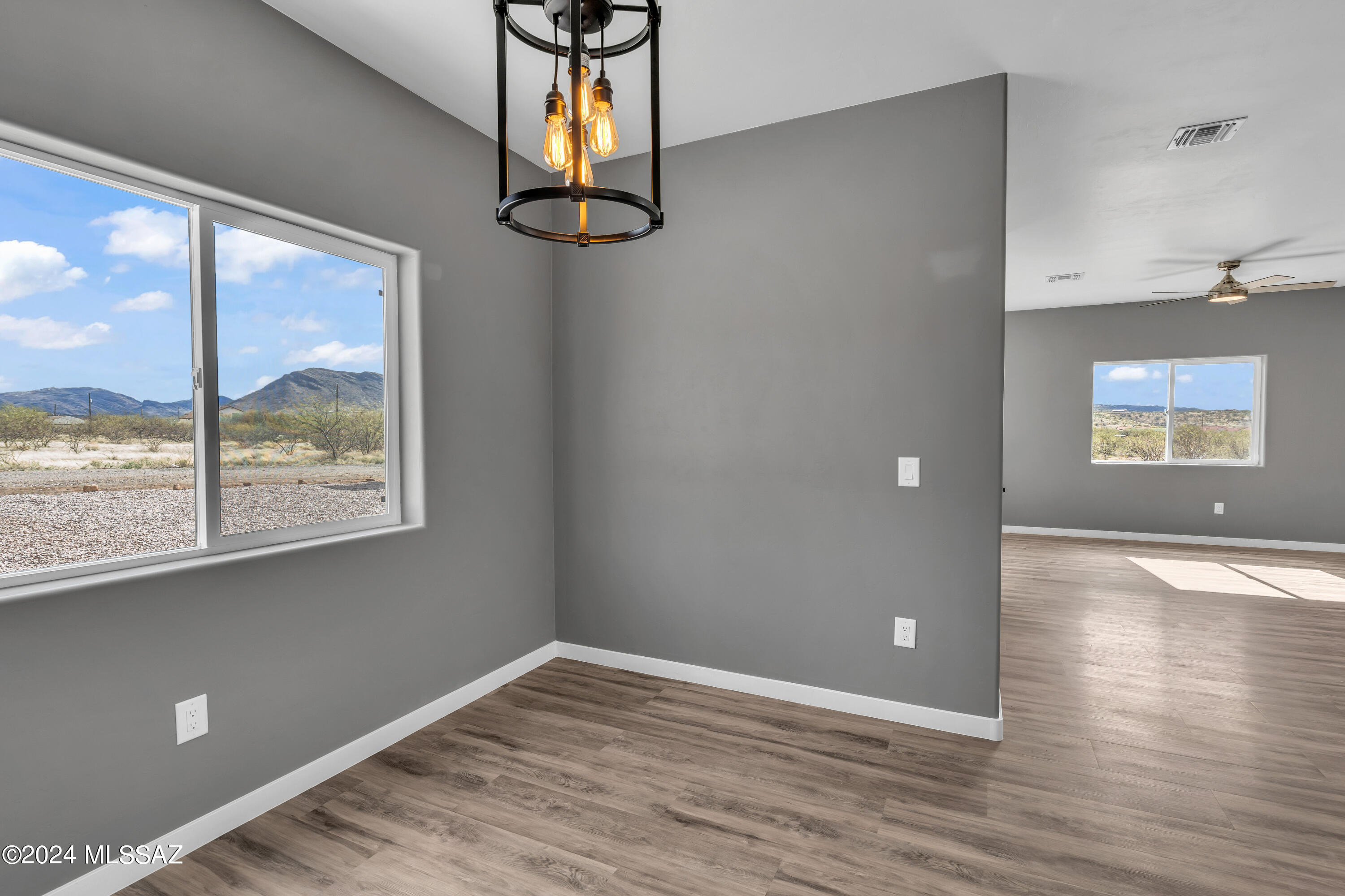 1840 La Paz Court Rio Rico, AZ 85648 - Photo 11 of 25 a view of an empty room with window and wooden floor