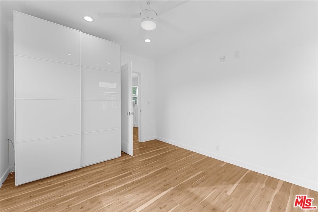 2948 Exposition Boulevard, Unit 7 Santa Monica, CA 90404 - Photo 13 of 15 an empty room with wooden floor and windows