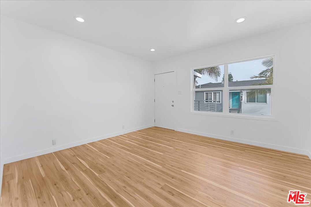 2948 Exposition Boulevard, Unit 7 Santa Monica, CA 90404 - Photo 6 of 15 a view of empty room with wooden floor and fan