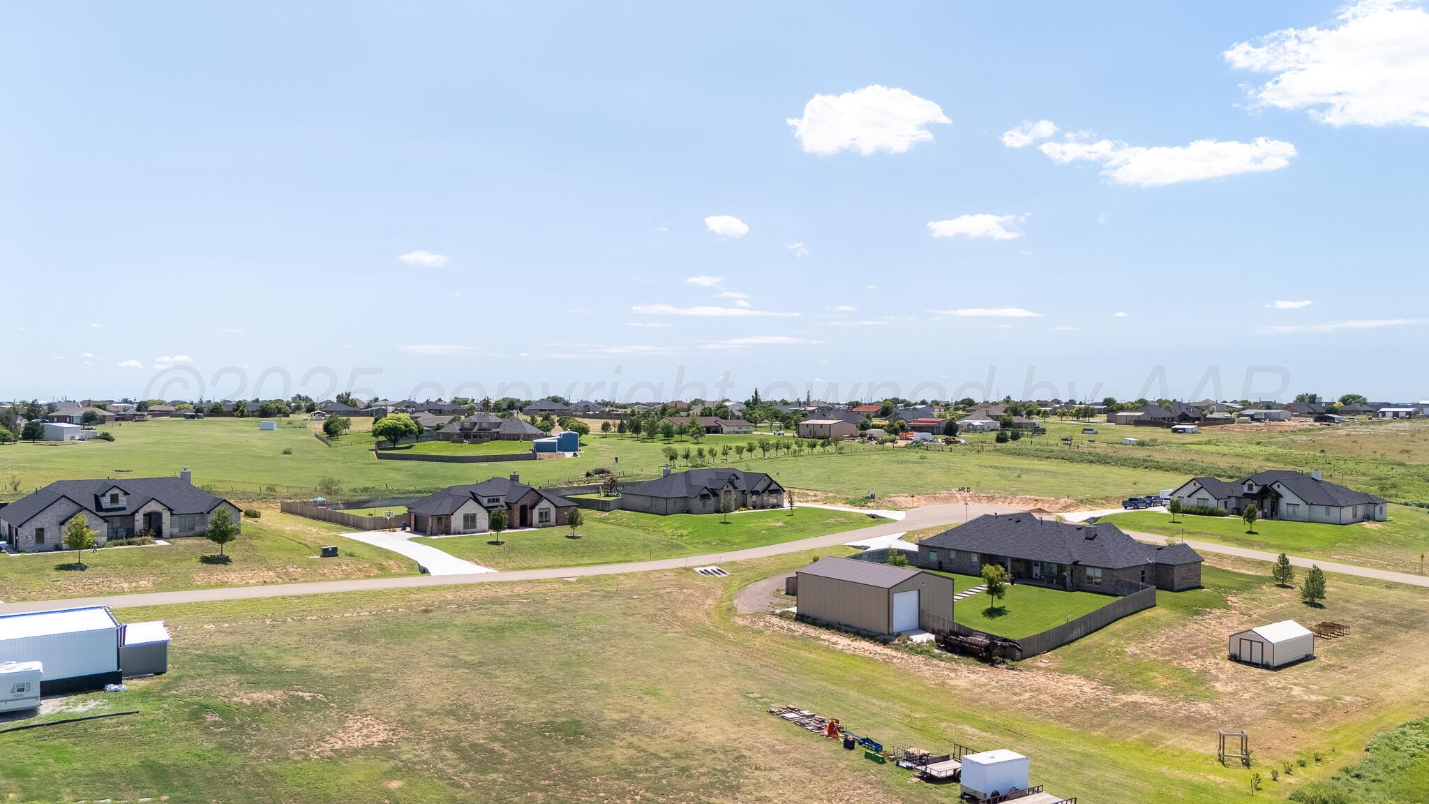 a view of a lake with a yard and outdoor seating