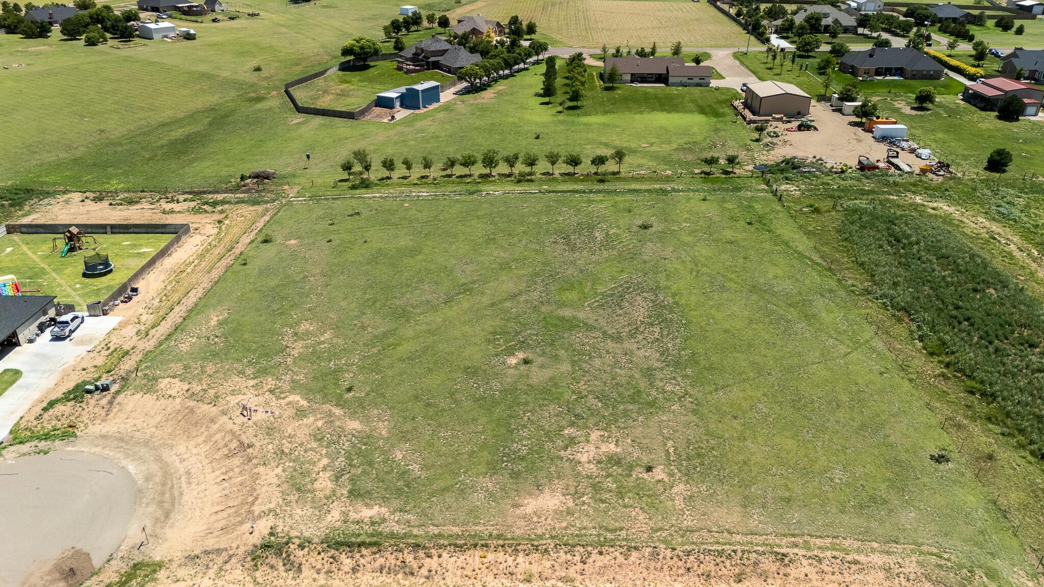 19851 Legacy Ranch Road Amarillo, TX 79124 - Photo 2 of 4 a view of a swimming pool with a yard