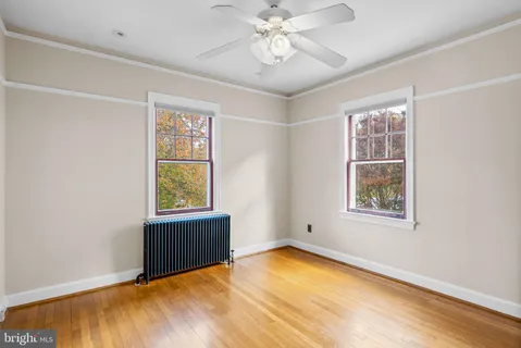 a view of an empty room with a window and closet area