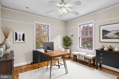 a livingroom with workspace couch and a window
