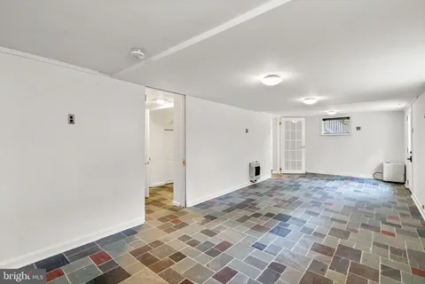 a bedroom with a bed and a lamp