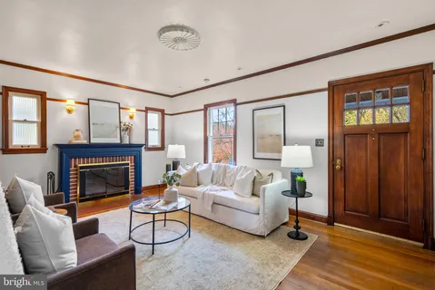 a living room with furniture a fireplace and a table