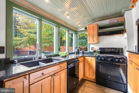 a kitchen with a sink a stove and cabinets