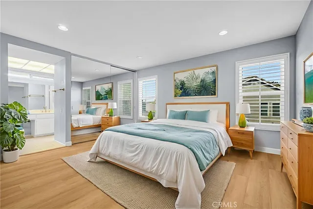 a spacious bedroom with a large bed and windows