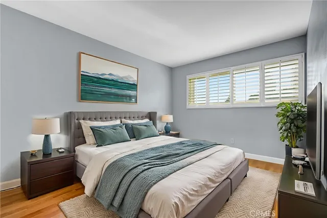 a bedroom with bed lamp and window