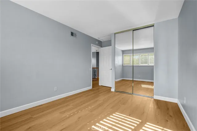 an empty room with wooden floor and door