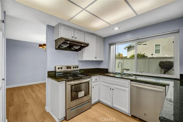 a kitchen with stainless steel appliances granite countertop a sink and stove top oven