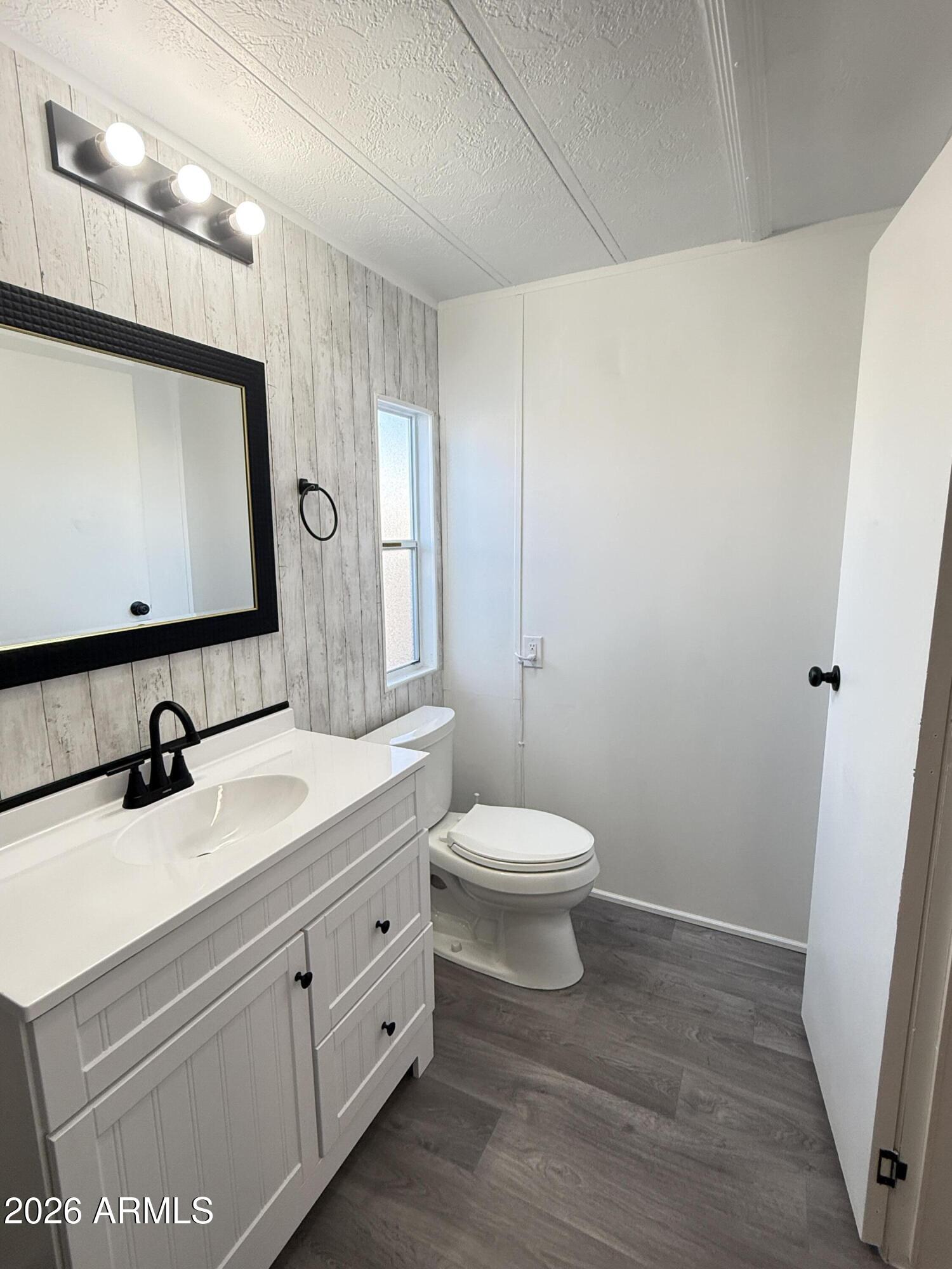 535 South Alma School Road, Unit 113 Mesa, AZ 85210 - Photo 18 of 41 a bathroom with a toilet sink and mirror