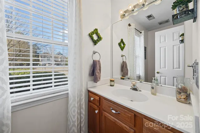 a bathroom with a sink double vanity and a mirror