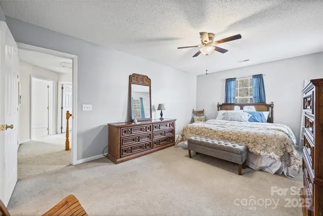 a bedroom with a bed and ceiling fan