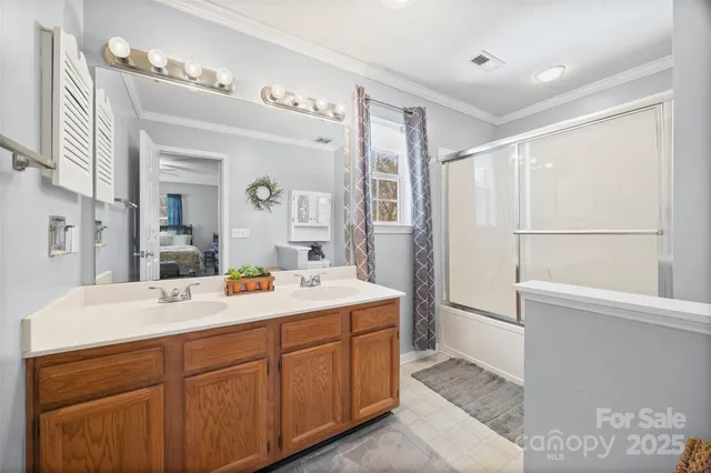 a spacious bathroom with a double vanity sink mirror and bathtub