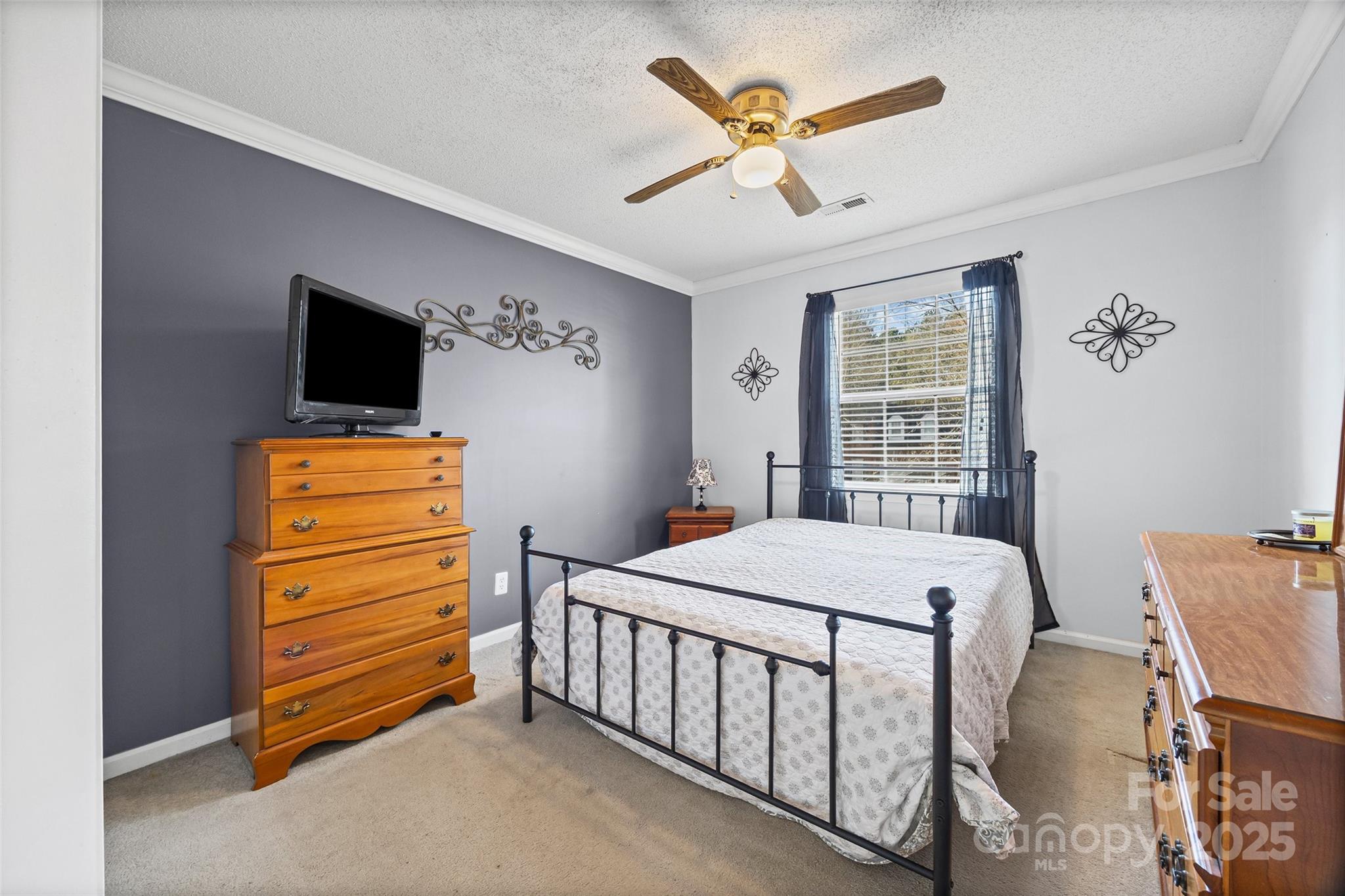 1337 Windsor Ridge Drive Rock Hill, SC 29732 - Photo 18 of 25 a bedroom with a bed a chandelier and a flat tv screen on dresser
