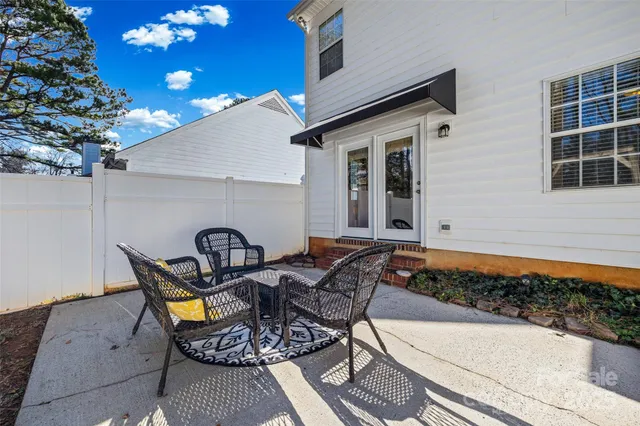 a view of a chairs and table in backyard