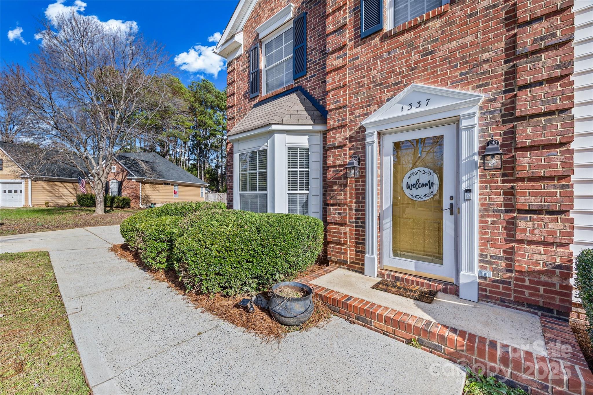 1337 Windsor Ridge Drive Rock Hill, SC 29732 - Photo 3 of 25 front view of a brick house with a small yard