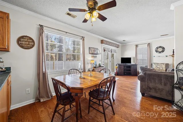 a view of a dining room with furniture and a chandelier