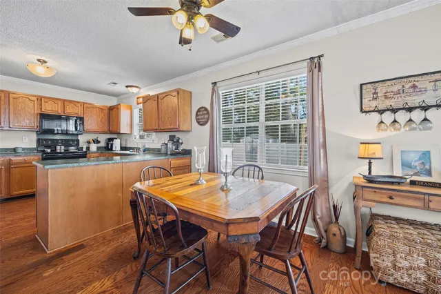 a dining table with chairs and window