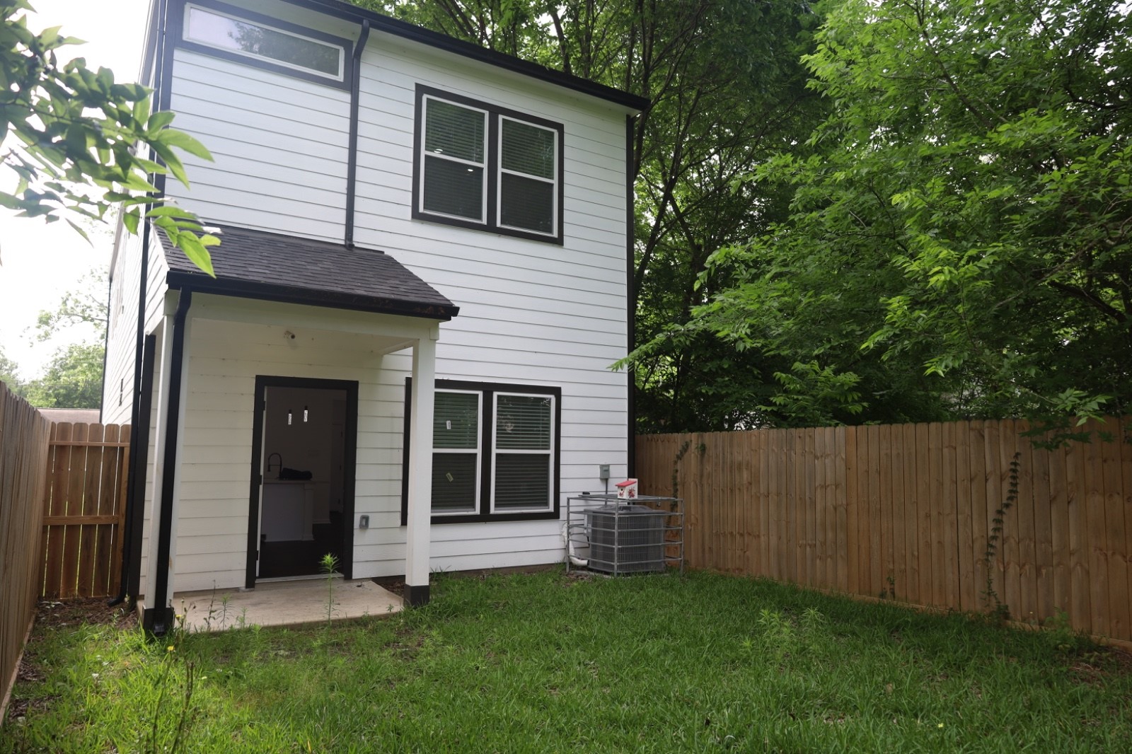 6614 Foster Street Houston, TX 77021 - Photo 14 of 15 a view of a backyard with potted plants and a large tree